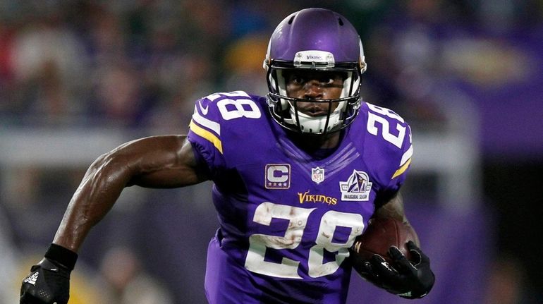 Minnesota Vikings running back Adrian Peterson carries the ball during...