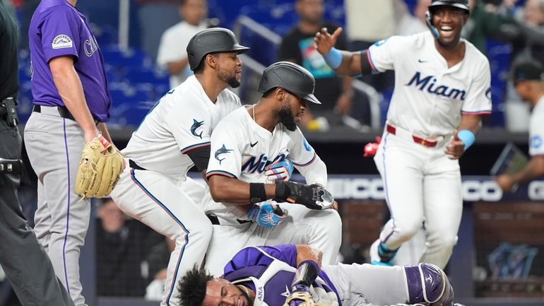 Miami Marlins' Otto Lopez picks up Bryan De La Cruz...