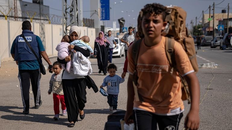 Palestinians arrive at Rafah, the border crossing between the Gaza...