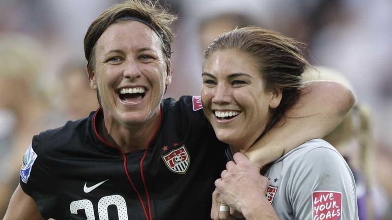 United States' Abby Wambach, left, and Hope Solo celebrate winning...