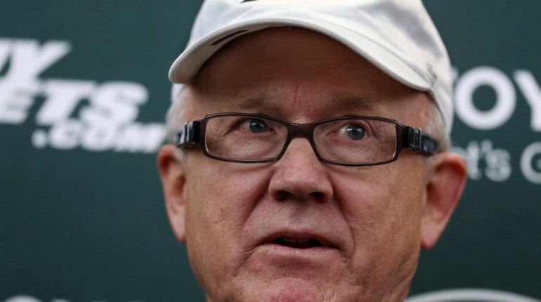 New York Jets owner Woody Johnson answers a question as...