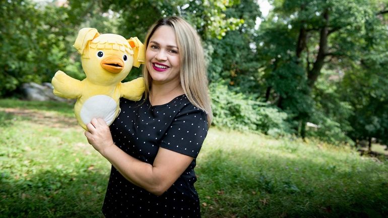 Marilyn Duque of Bayside and her yellow chick puppet named Myla.