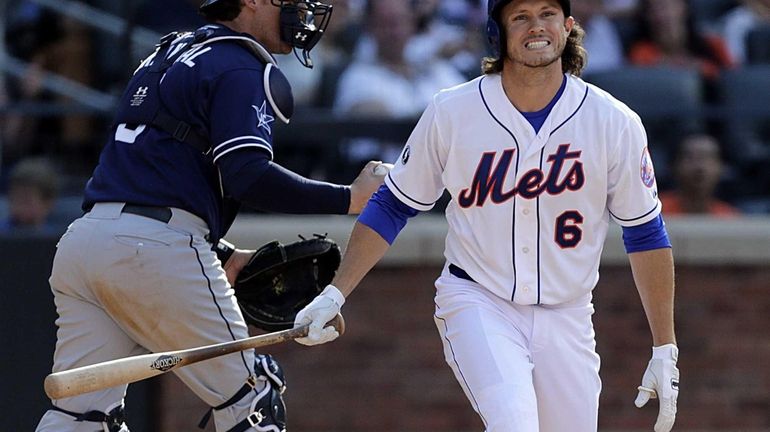 Mets centerfielder Matt den Dekker reacts after striking out with...