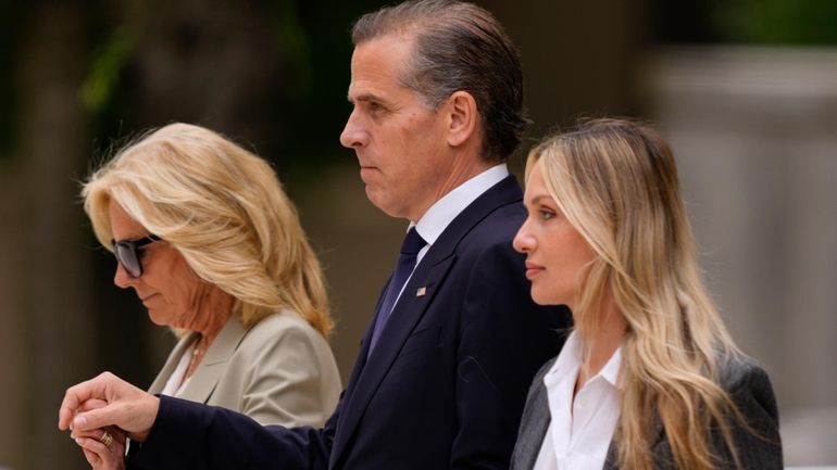 Hunter Biden, center, President Joe Biden's son, accompanied by his...