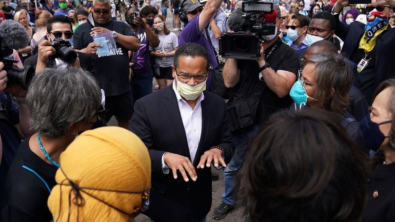 Minnesota Attorney General Keith Ellison, center, speaks with Rep. Ilhan...