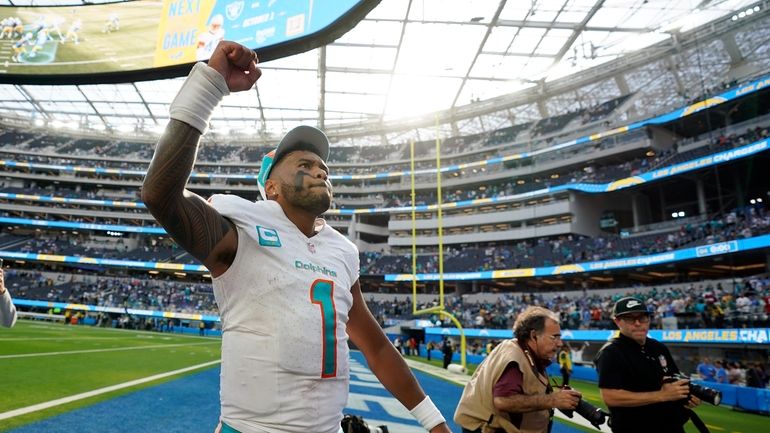 Miami Dolphins quarterback Tua Tagovailoa celebrates after a 36-34 win...