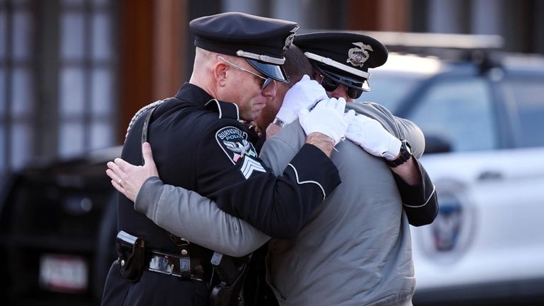 Taylor Jacobs, center, who was with Burnsville Police for 10...