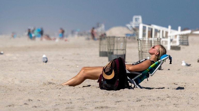 Emma Haverilla, 22, of Northport, tries to stay cool along...