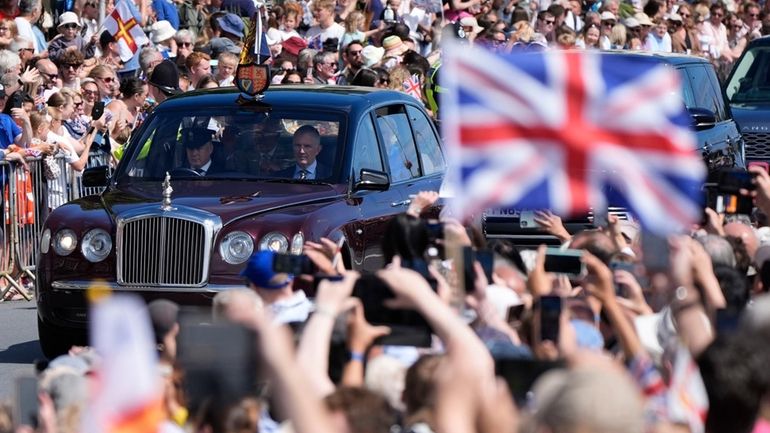 Britain's King Charles III and Queen Camilla arrive to attend...