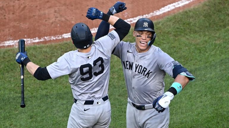 The Yankees' Aaron Judge, right, celebrates after his solo home...