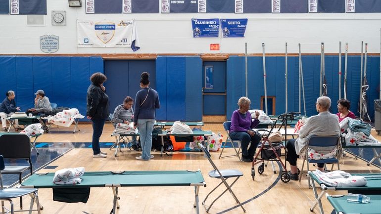 People shelter at New Hyde Park Memorial High School on...