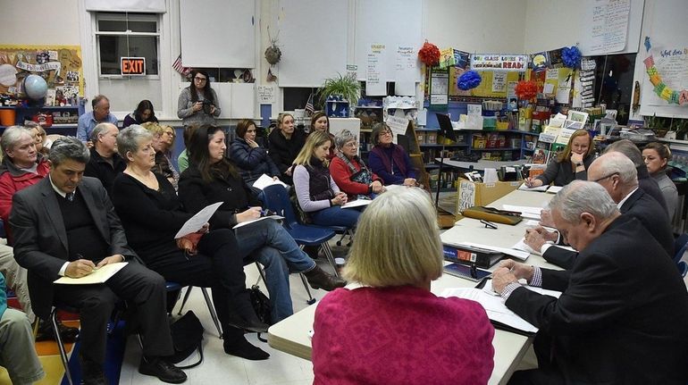 People sit in a classroom and listen as the New...