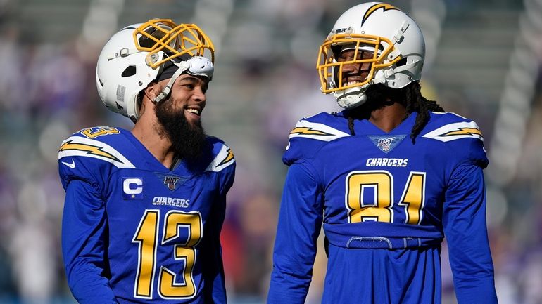 FILE - Los Angeles Chargers wide receivers Keenan Allen, left,...