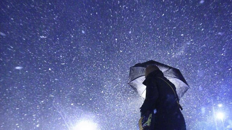 Sheril Pitters, of Coram, braves the snowstorm on Jan. 21,...