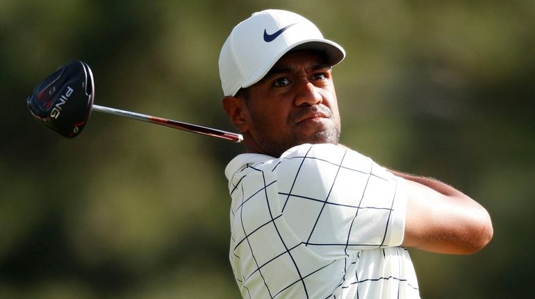 Tony Finau hits his tee shot on the eighteenth hole...