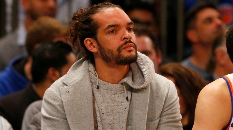 Joakim Noah of the Knicks looks on from the bench...