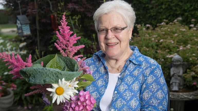 Helga K. Breen of Riverhead holds a bouquet of fresh...