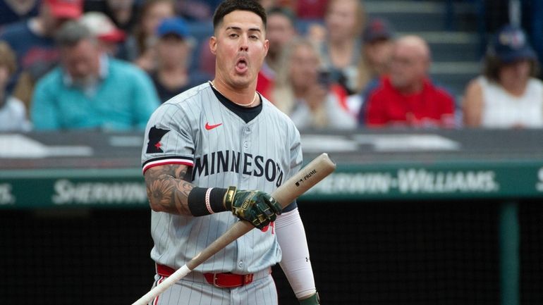 Minnesota Twins' Jose Miranda reacts between pitches from Cleveland Guardians...