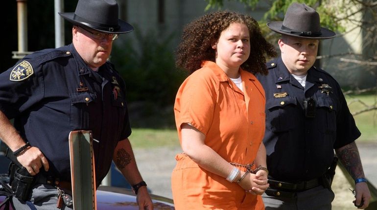 Sheriff deputies walk Sarra Gilbert into a courthouse in upstate...