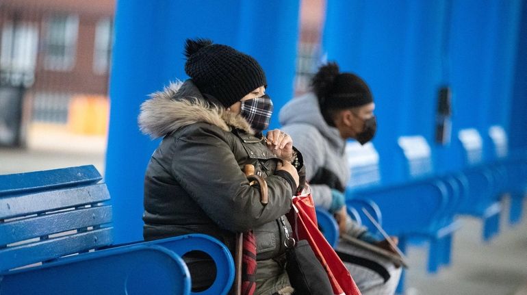 A woman at the bus stop Saturday at the Rosa...