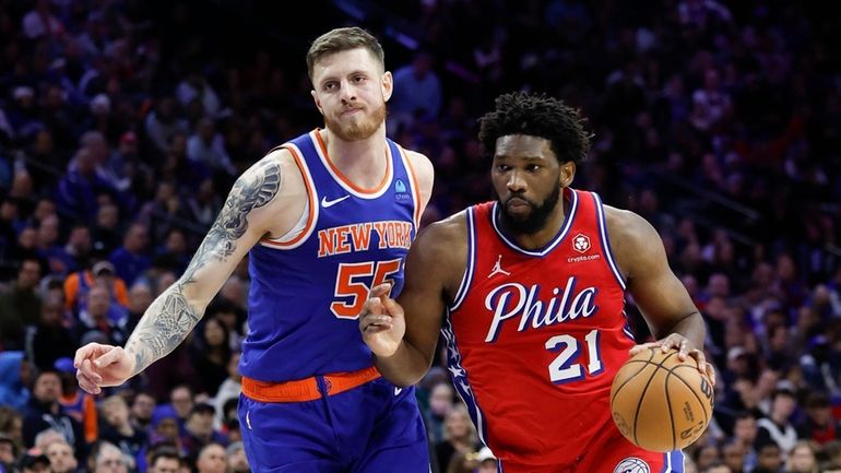 Sixers center Joel Embiid dribbles the basketball against New York...