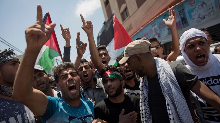 Palestinians protest during the funeral of volunteer paramedic, Razan Najjar,...