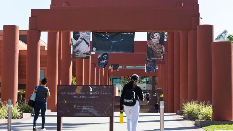 Students walk past the Harriet and Charles Luckman Fine Arts...