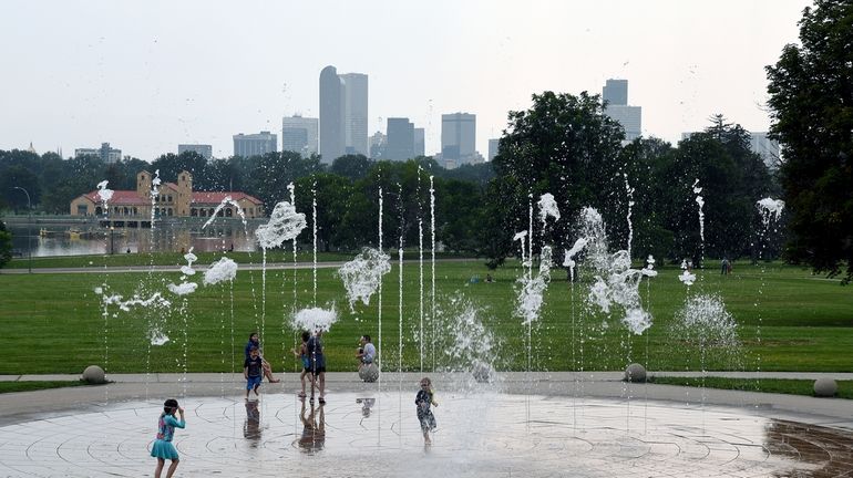 Haze hangs in the air as children play in a...