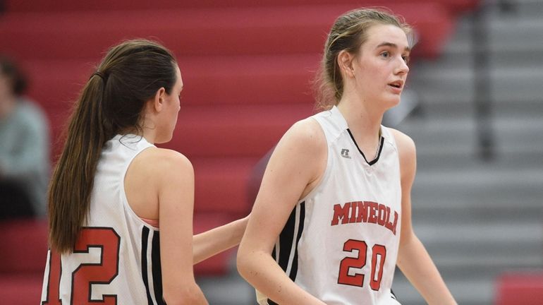 Caitlin Kenney of Mineola, right, gets a pat on the back...