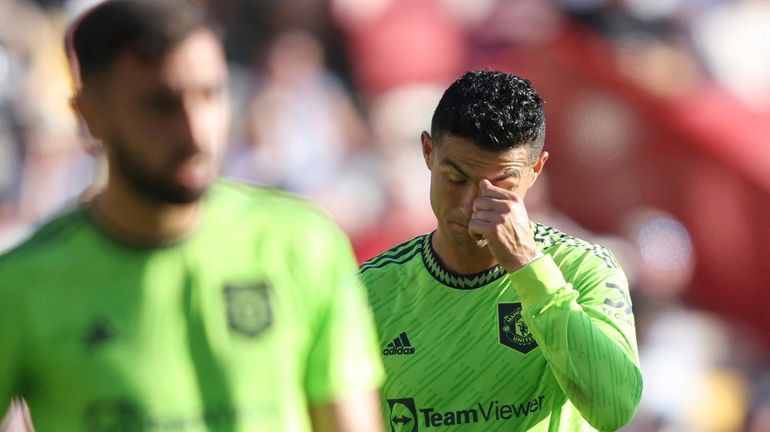 Manchester United's Cristiano Ronaldo right reacts as his team lose...