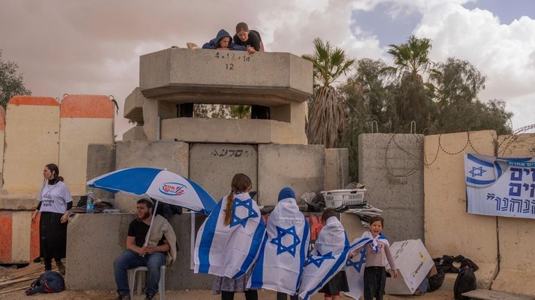 People gather at Israel's Nitzana border crossing with Egypt in...