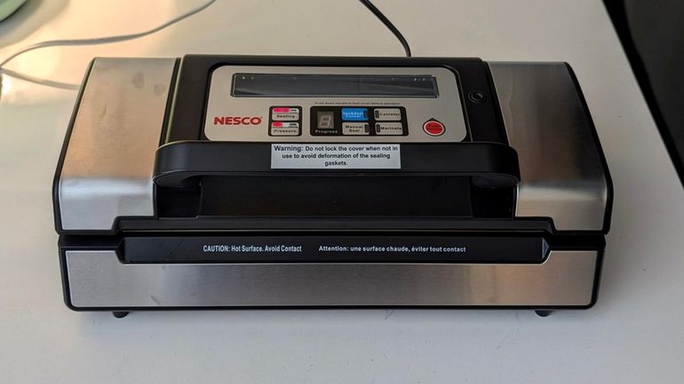 The Nesco VS 12 vacuum sealer's push-down handle locks easily.