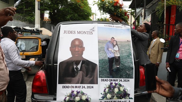 A funeral procession for mission director Judes Montis, killed by...