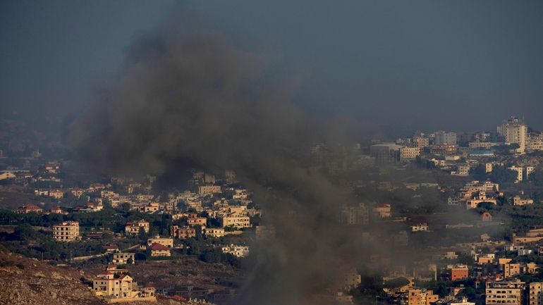 Smoke rises from an Israeli airstrike on Kfar Rouman village,...