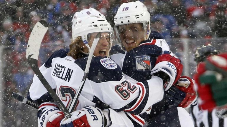 Carl Hagelin celebrates with Marc Staal after scoring a goal...