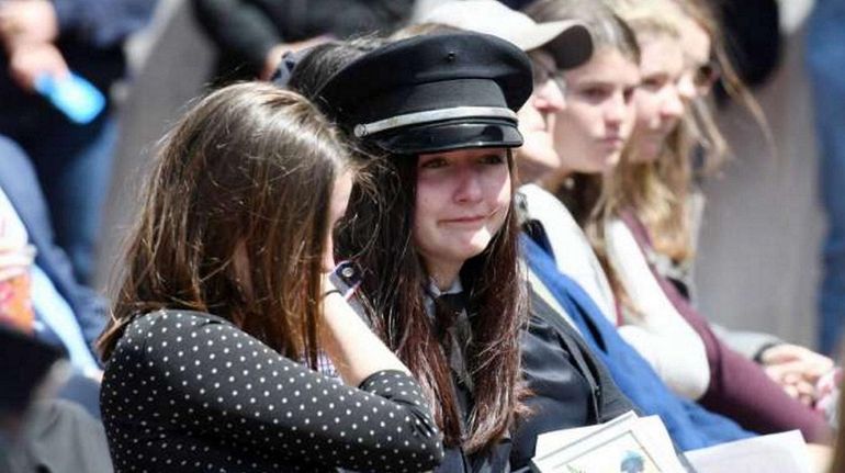 From left, Caroline Ryan, 17, and Michaela Ryan, 19, tear...