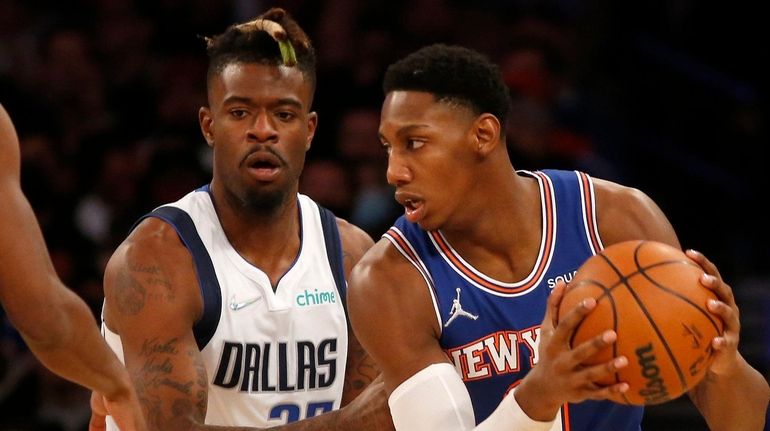 RJ Barrett of the Knicks controls the ball against Reggie Bullock of the...