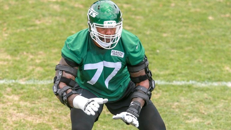 Jets tackle Tyron Smith does a drill during minicamp at the team's...