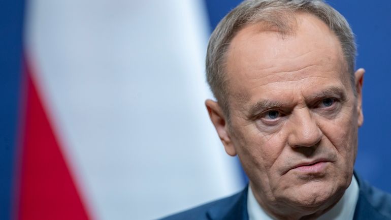 Poland's Prime Minister Donald Tusk pauses as he speaks, during...