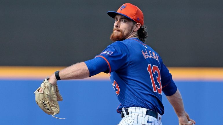 Nolan McLean of the Mets throws a warm-up pitch prior to...