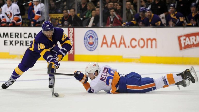 Islanders center Brock Nelson battles for possession with Los Angeles...