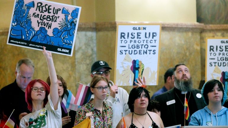 Kansas high school students, family members and advocates rally for...