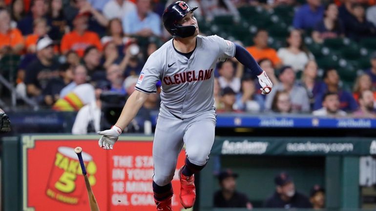 Cleveland Guardians' designated hitter Will Brennan flips his bat as...