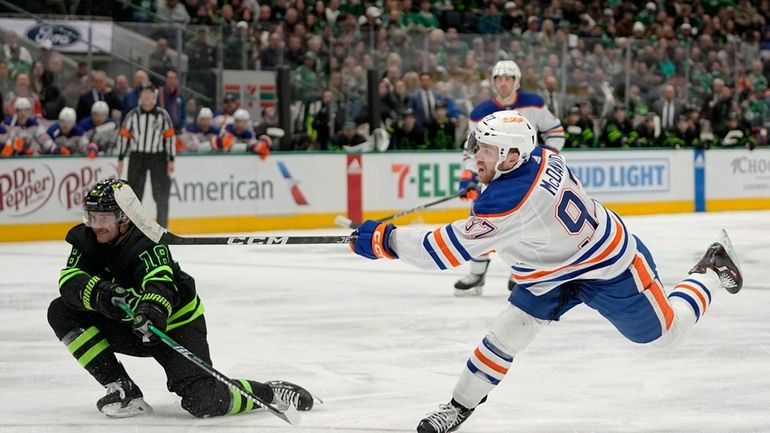 Edmonton Oilers' Connor McDavid (97) takes a shot as Dallas...