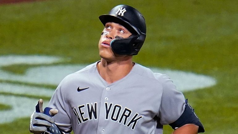 The Yankees' Aaron Judge runs the bases after hitting a...