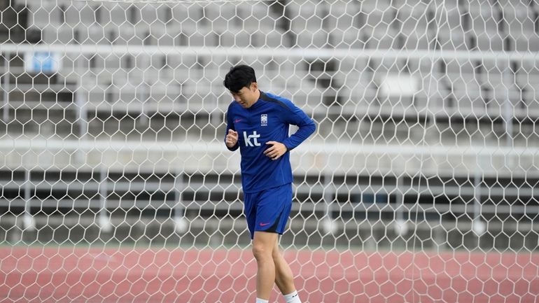 South Korea's Son Heung-min warms up during an open training...