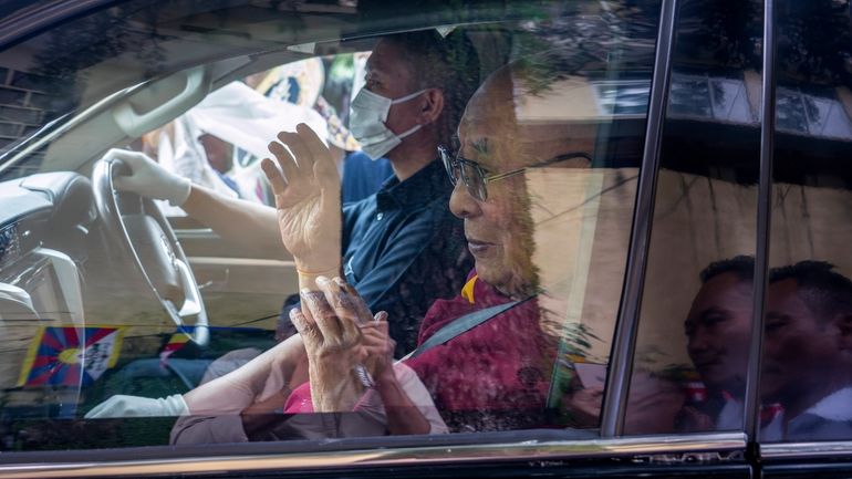 Tibetan spiritual leader the Dalai Lama greets a welcoming crowd...