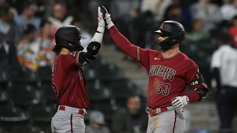 Arizona Diamondbacks' Christian Walker (53) celebrates with teammate Alek Thomas...