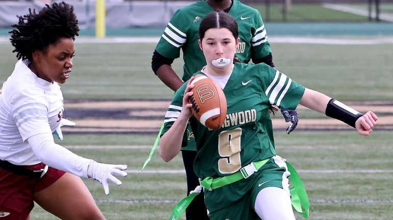 Longwood QB Delaney Israel takes the keeper upfield and avoids Sachem...