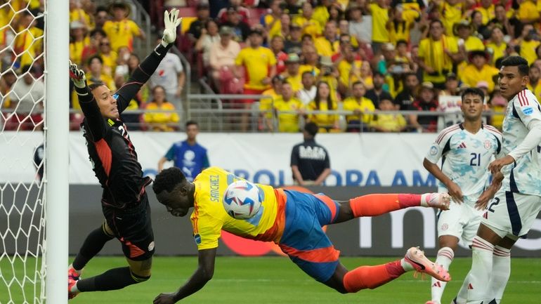 Costa Rica's goalkeeper Patrick Sequeira, left, makes a save after...